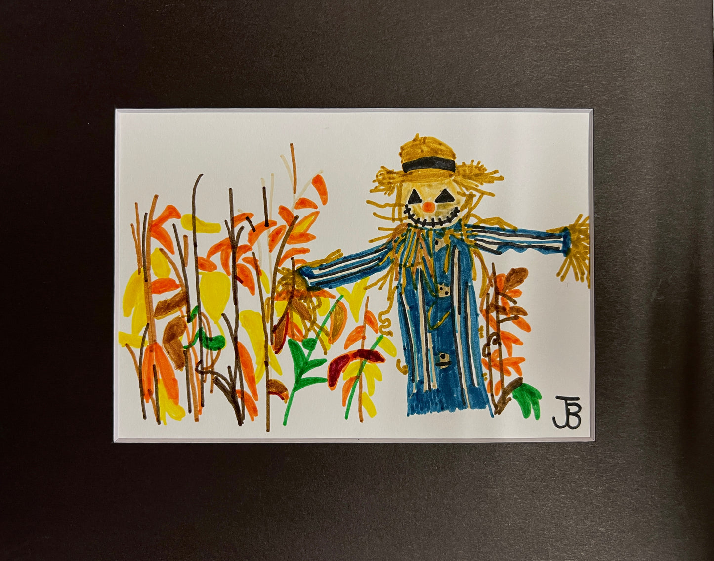 Scarecrow in Fall Leaves